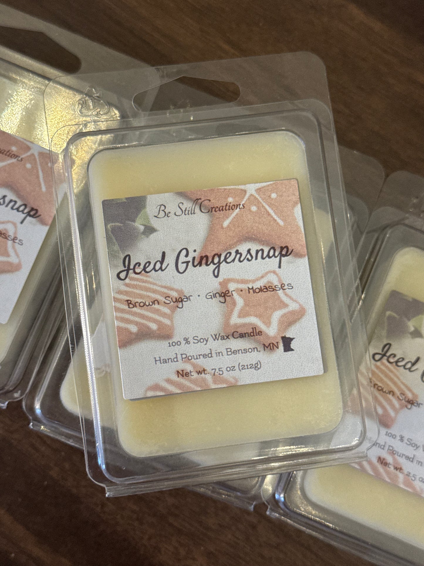 Wax melt in packaging with 'Iced Gingersnap' label on a wooden surface