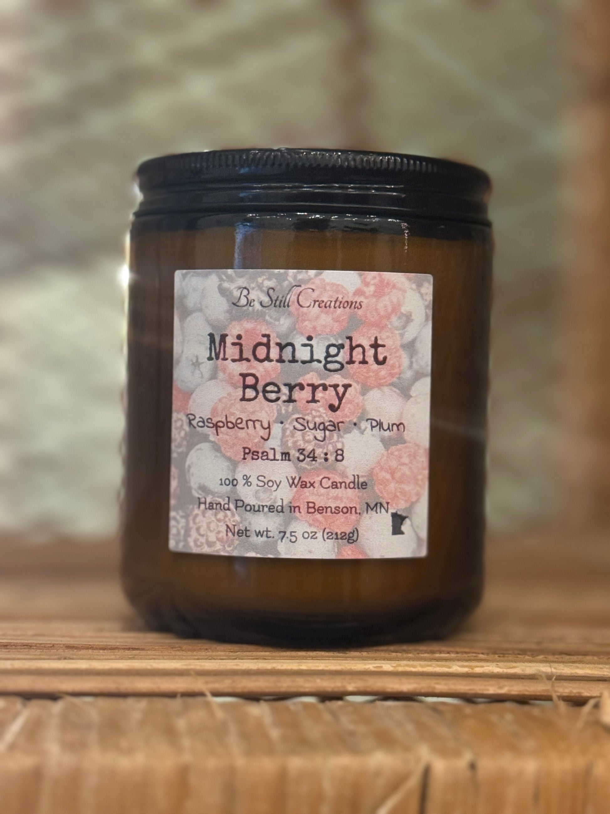 Close-up of Midnight Berry candle label showing raspberry, sugar, and plum fragrance notes