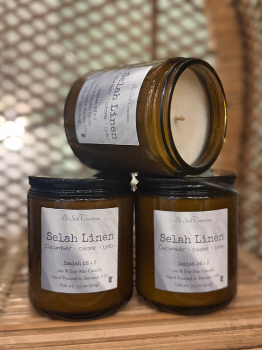 Selah Linen soy candle in clear glass jar with white wax and black lid, cucumber ozone linen scent