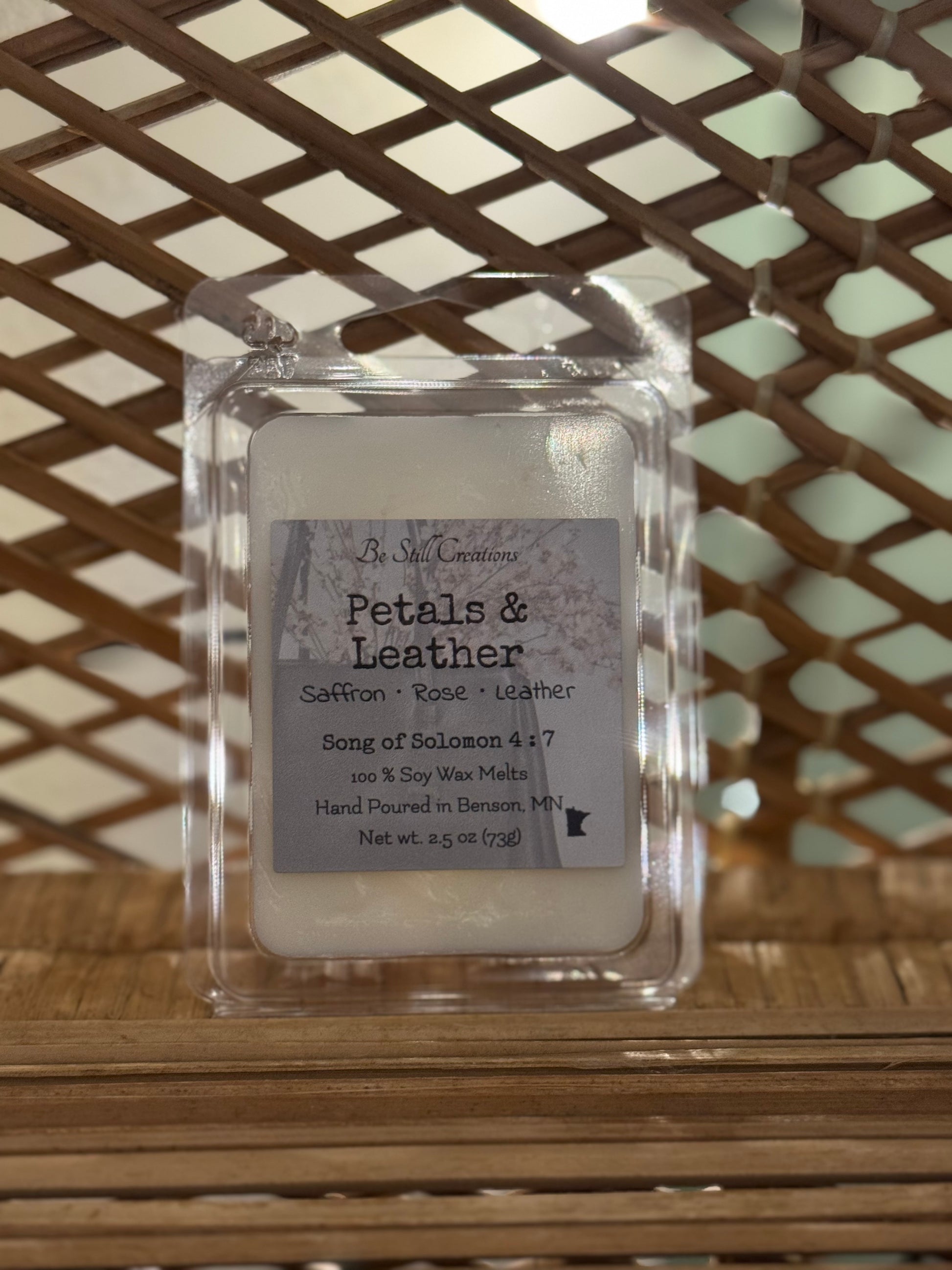 Close-up of Petals & Leather wax melts label showing saffron, rose, and leather fragrance notes