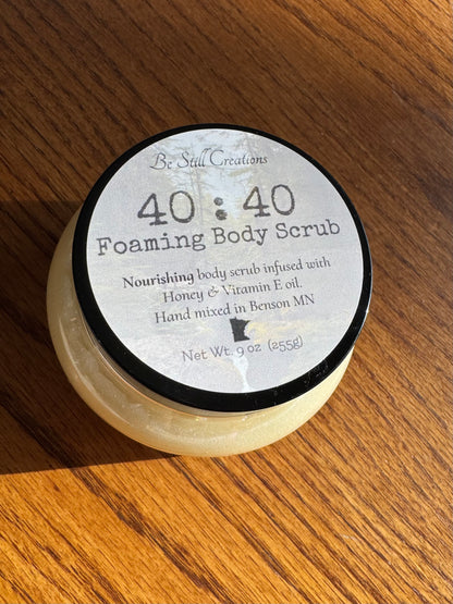40:40 Foaming Body Scrub container on a wooden surface