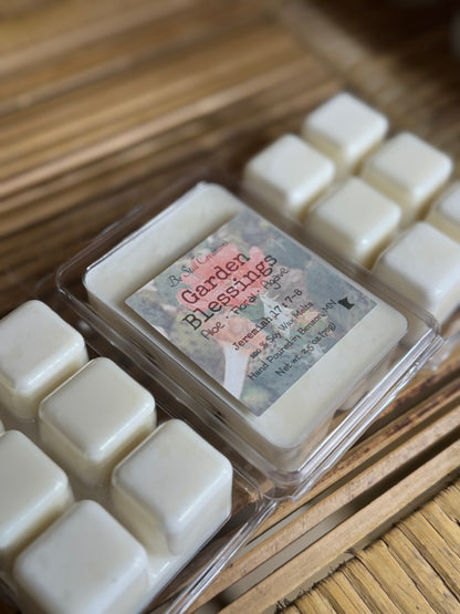 Packaged floral scented soy wax melts with a label on a wooden surface